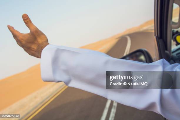 arab man in desert, abudhabi, united arab emirates - arab driving stock-fotos und bilder