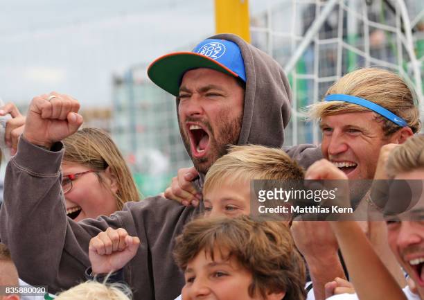 Rapper and Supporter Marteria of Rostock and Christoph Thuerk show their delight after winning the final match between Rostocker Robben and...