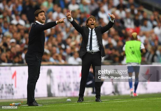 Antonio Conte, Manager of Chelsea reacts as Mauricio Pochettino, Manager of Tottenham Hotspur gives his team instructions during the Premier League...