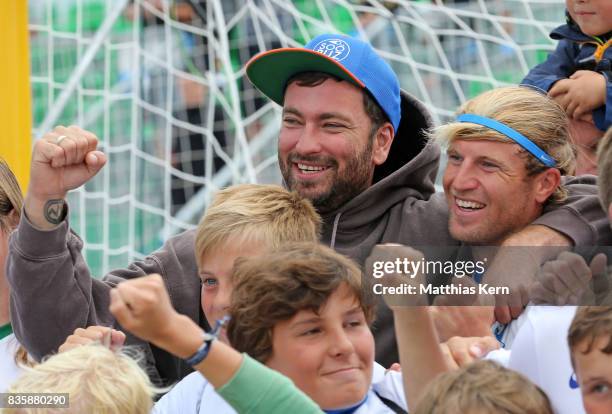 Rapper and Supporter Marteria of Rostock and Christoph Thuerk show their delight after winning the final match between Rostocker Robben and...