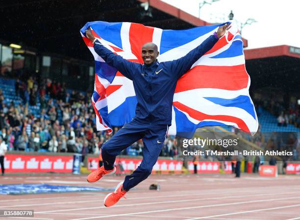 Mo Farah poses with the Union Flag after winning the men's 3000m during the Muller Grand Prix and IAAF Diamond League event at Alexander Stadium on...