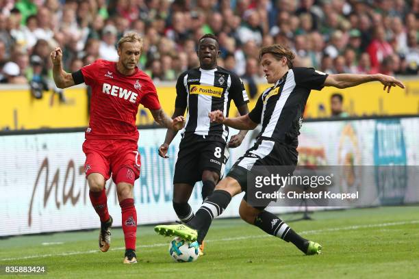 Marcel Risse of Koeln , Denis Zakaria of Moenchengladbach and Jannik Vestergaard of Moenchengladbach during the Bundesliga match between Borussia...