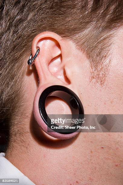 male ear lobe with ear gauge  - earlobe ストックフォトと画像
