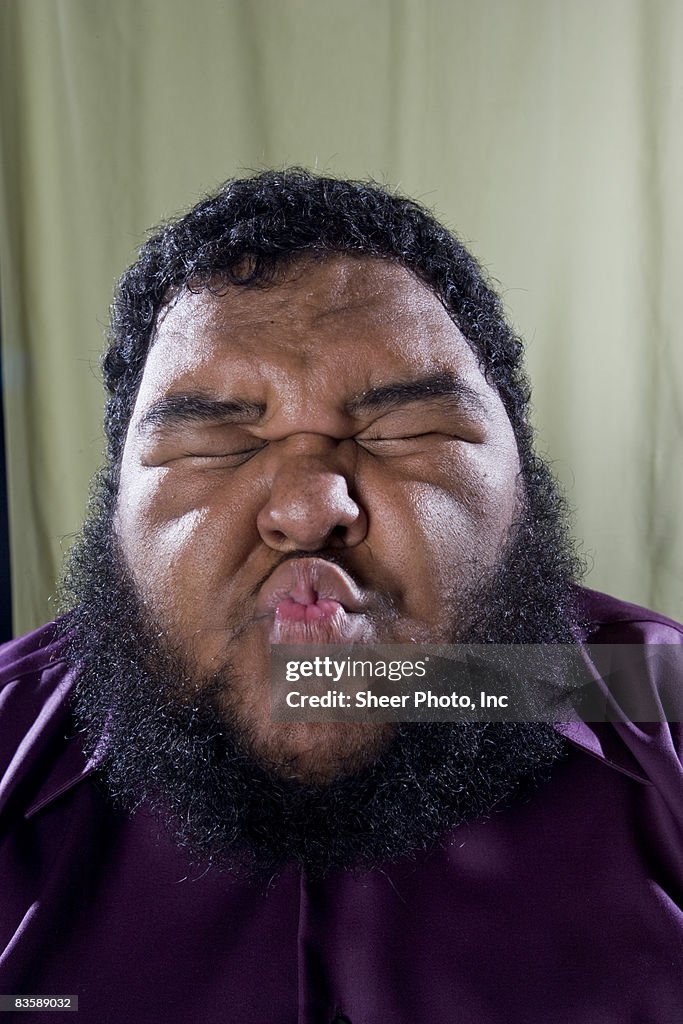 Large man with lips puckered