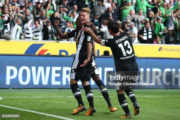 Nico Elvedi of Moenchengladbach celebrates having scored his teams first goal with Ibrahima Traore of Moenchengladbach and Lars Stindl of...
