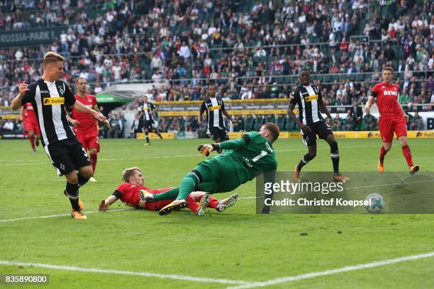 Nico Elvedi of Moenchengladbach scores his teams first goal past goalkeeper Timo Horn of Koeln during the Bundesliga match between Borussia...