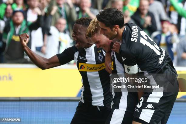 Nico Elvedi of Moenchengladbach celebrates having scored his teams first goal with Ibrahima Traore of Moenchengladbach and Lars Stindl of...