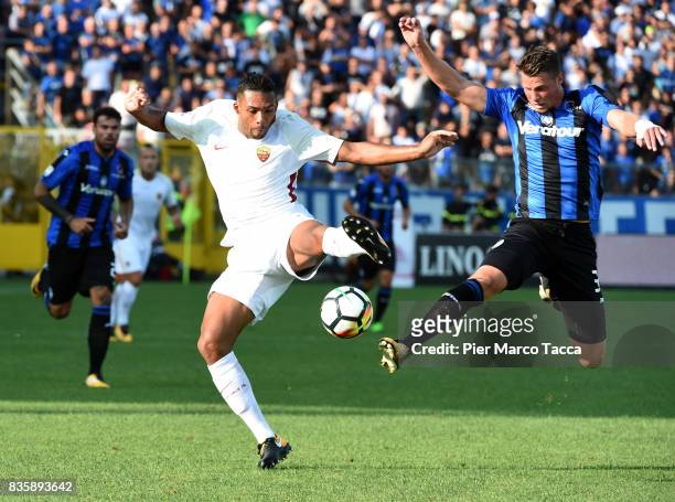Juan Jesus of AS Roma competes for the ball with Hans Hateboer of Atalanta BC during the Serie A match between Atalanta BC and AS Roma at Stadio...
