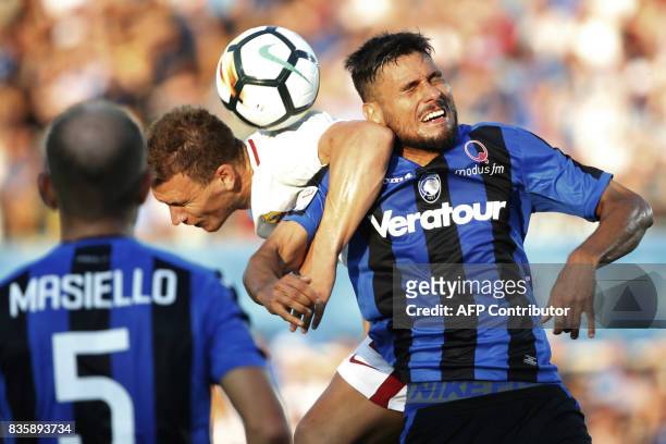 Roma's Bosnian forward Edin Dzeko vies with Atalanta's Bosnian defender Ervin Zukanovic during the Italian Serie A football match between Atalanta...