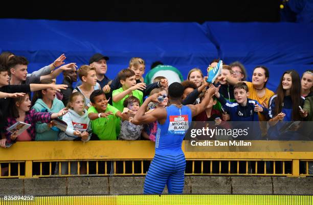 Nethaneel Mitchell-Blake of Great Britain gives his running shoes away to children following the Mens 200m during the Muller Grand Prix Birmingham...