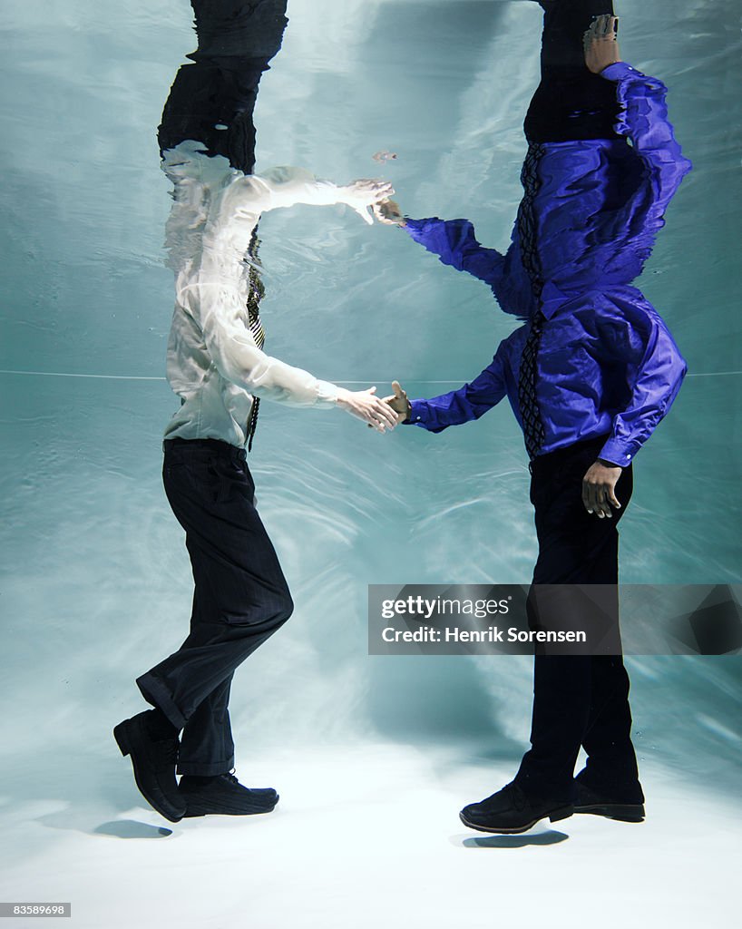 Buisnessmen shaking hands under water