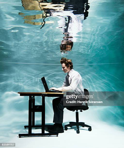 buisnessman working at his computer under water - out of context ストックフォトと画像