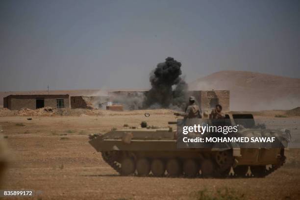 Smoke billows as Iraqi government forces supported by fighters from the Abbas Brigade, which fights under the umbrella of the Shiite popular...