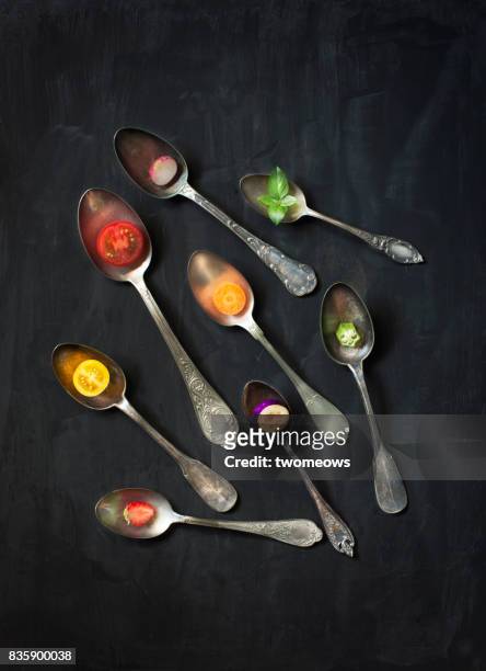 Colourful cut vegan food with vintage old fashion metal spoons.