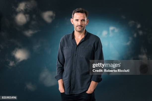 Scottish-South African author Jason Donald attends a photocall during the annual Edinburgh International Book Festival at Charlotte Square Gardens on...