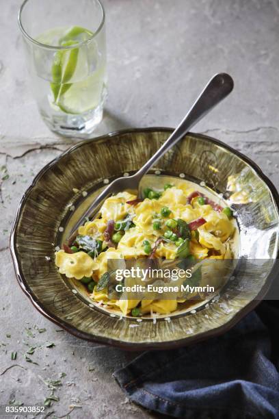 ravioli with green peas and pancetta - pancetta stock pictures, royalty-free photos & images