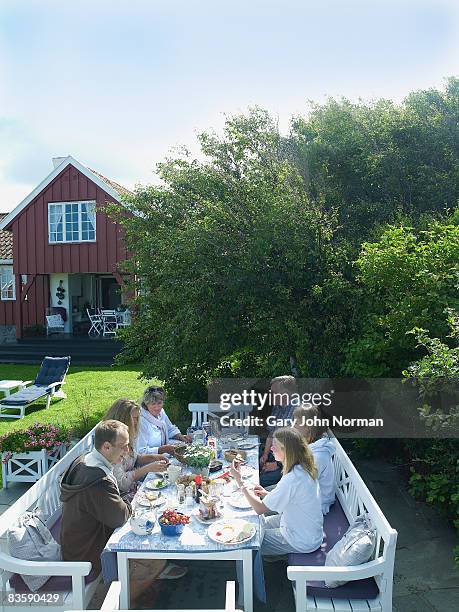 family enjoying breakfast outside - norman elder stock-fotos und bilder