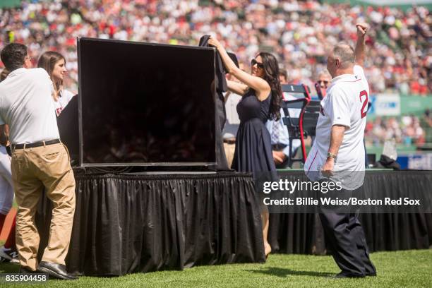 Broadcaster Jerry Remy is presented with a gift during a 30 year recognition ceremony before a game between the Boston Red Sox and the New York...