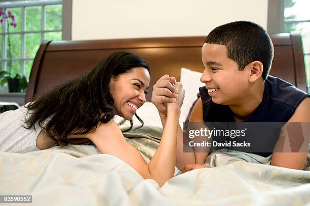 mother and son arm wrestling - female wrestling holds stock pictures, royalty-free photos & images