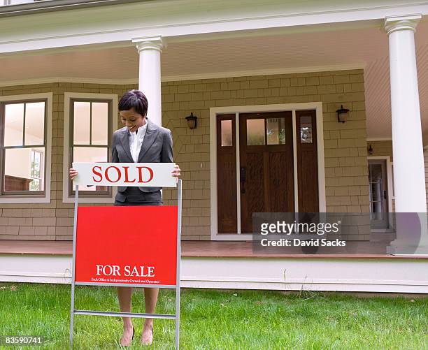 real estate agent with sale sign - real estate agent stock pictures, royalty-free photos & images