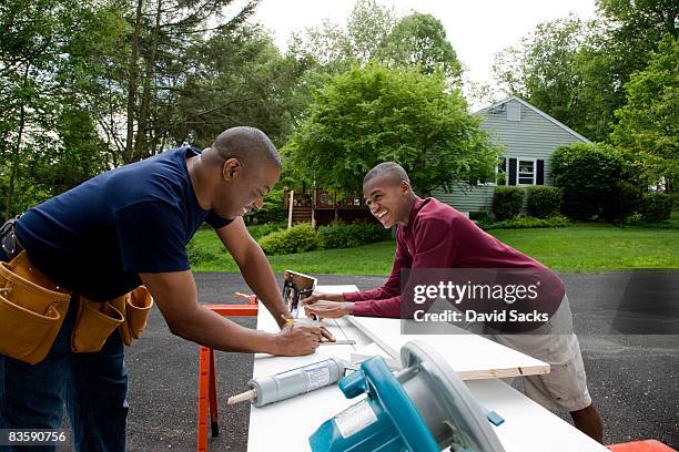 father and son working on house - teen son stock pictures, royalty-free photos & images