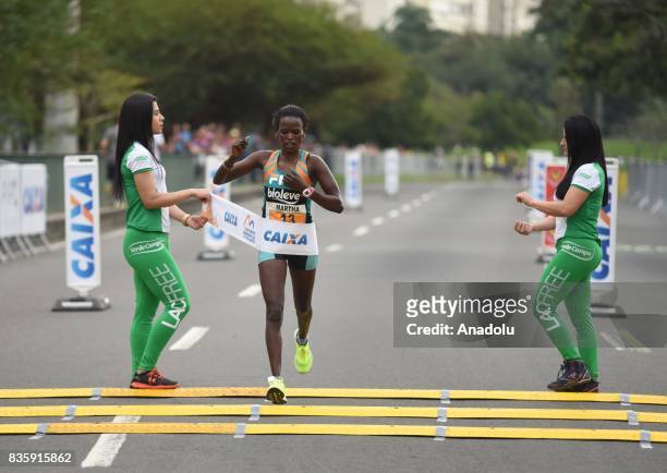 Martha Akeno of Ethiopia crosses the finish line in first place during the Rio de Janeiro International Women's Half Marathon in Rio de Janeiro,...