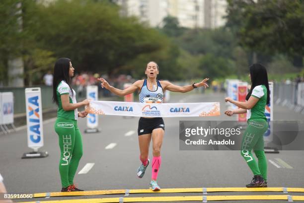 Andréia Aparecida Hessel of Brazil crosses the finish line in fifth place during the Rio de Janeiro International Women's Half Marathon in Rio de...