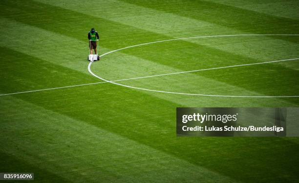 Greenkeeper marks the lines of the pitch prior to the Bundesliga match between Borussia Moenchengladbach and 1. FC Koeln at Borussia-Park on August...