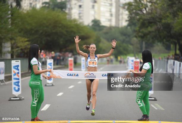 Adriana Aparecida da Silva of Brazil crosses the finish line in fourth place during the Rio de Janeiro International Women's Half Marathon in Rio de...