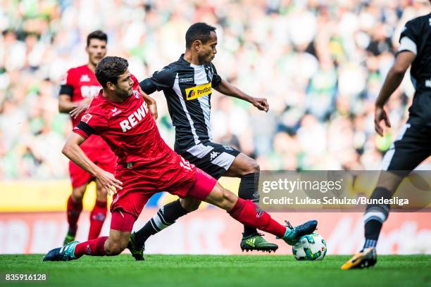 Raffael of Moenchengladbach and Jonas Hector of Koeln fight for the ball during the Bundesliga match between Borussia Moenchengladbach and 1. FC...