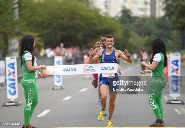 José Marcio Leão da Silva of Brazil crosses the finish line in first place during the Rio de Janeiro International Half Marathon in Rio de Janeiro,...