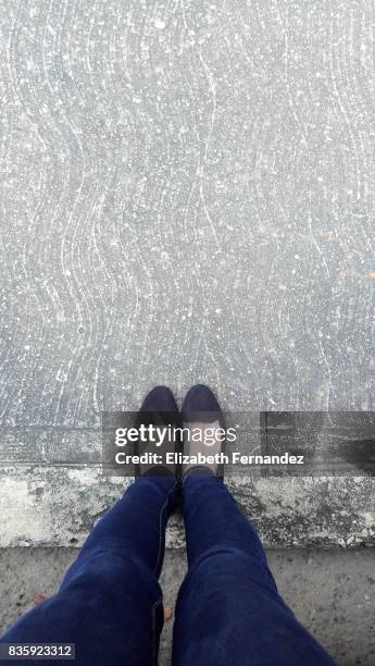 low section of woman standing on concrete - schuhe frau von oben stock-fotos und bilder