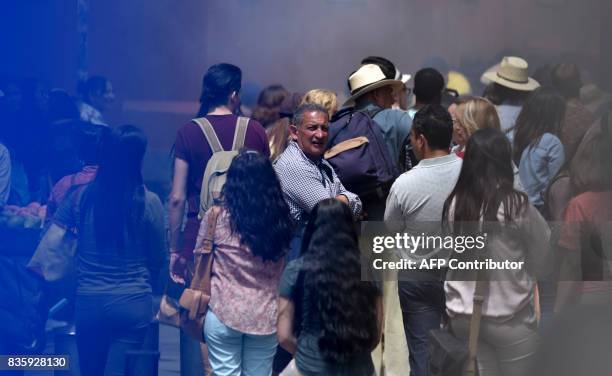 People acting as extras are seen on a street closed to the traffic during the filming of scenes of the movie "Godzilla, King of the Monsters" in the...