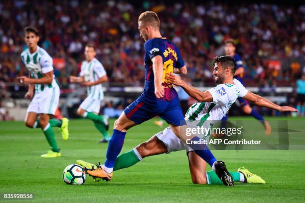 Barcelona's forward Gerard Deulofeu vies with Betis' forward Alex Alegria during the Spanish league footbal match FC Barcelona vs Real Betis at the...