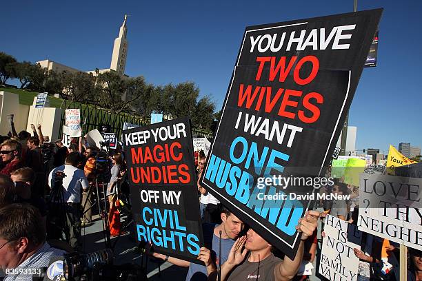 Supporters of same-sex marriage demonstrate near the Los Angeles Mormon Temple, in the distance, before marching for miles in protest against the...