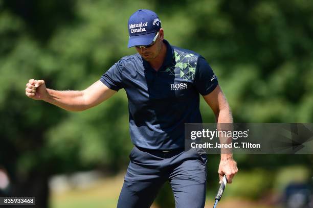 Henrik Stenson of Sweden reacts after making his birdie putt on the seventh green during the final round of the Wyndham Championship at Sedgefield...