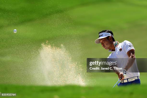 Kevin Na plays his third shot from the bunker on the fifth hole during the final round of the Wyndham Championship at Sedgefield Country Club on...