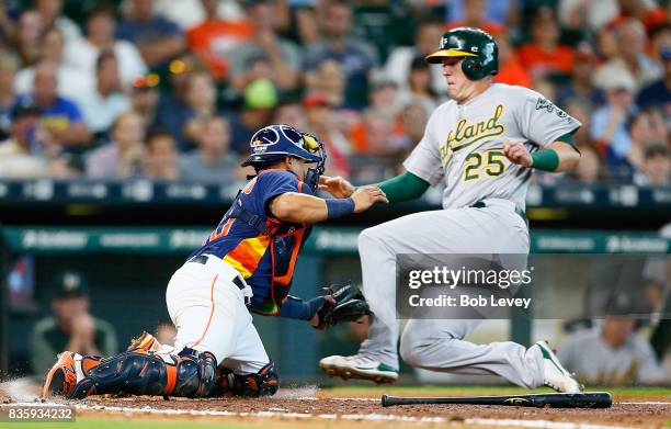 Juan Centeno of the Houston Astros tags out Ryon Healy of the Oakland Athletics in the sixth inning at Minute Maid Park on August 20, 2017 in...