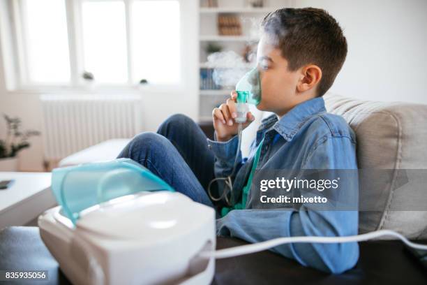 inhalating at home - asthma inhaler child stock pictures, royalty-free photos & images