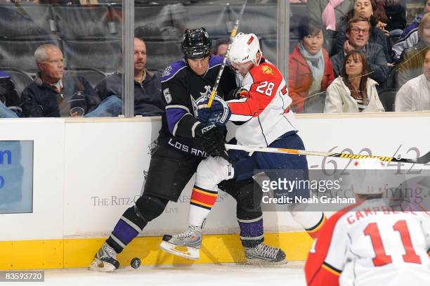 Kamil Kreps of the Florida Panthers battles for the puck alongside the boards against Sean O'Donnell of the Los Angeles Kings during the game at...