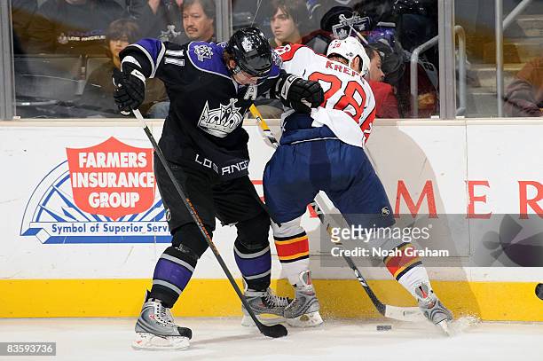 Kamil Kreps of the Florida Panthers fights for the puck against Anze Kopitar of the Los Angeles Kings during the game at Staples Center November 6,...