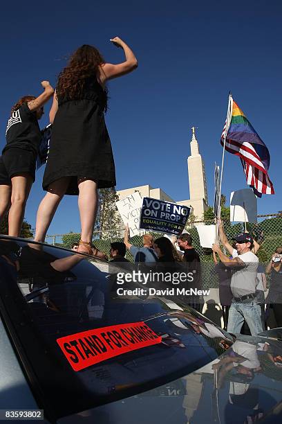 Supporters of same-sex marriage demonstrate near the Los Angeles Mormon Temple, in the distance, before marching for miles in protest against the...