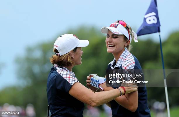 Juli Inkster the United States team captain embraces Lexi Thompson on the 18th green after Thompson had won the leading singles match against Anna...