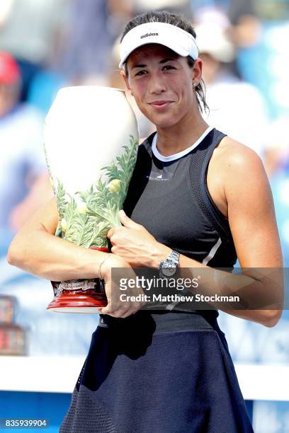 Garbine Muguruza of Spain poses with the winner's trophy after defeating Simona Halep of Romania during the women's final on day 9 of the Western &...