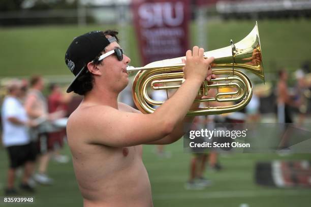 The student marching band practices on the campus of Southern Illinois University pafore participating in tomorrow's solar eclipse program being held...