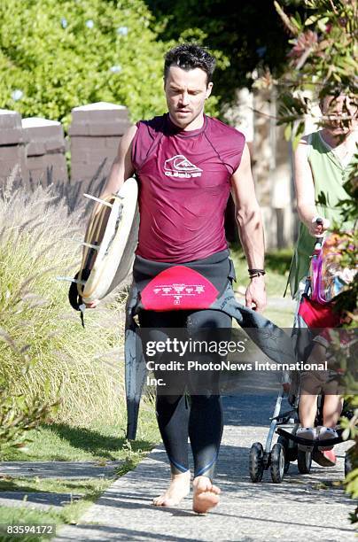Actor Damien Walsh-Howling is seen walking with his surfboard in Bondi Beach on November 7, 2008 in Sydney, Australia.