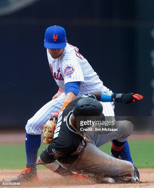 Dee Gordon of the Miami Marlins steals second base in the third inning ahead of the tag from Gavin Cecchini of the New York Mets at Citi Field on...
