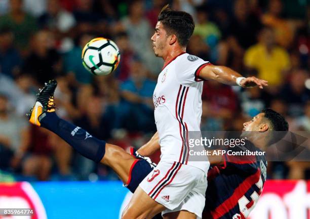 Milan's Portuguese forward Andre Silva vies for the ball with Crotone's Italian goalkeeper Marco Festa during the Italian Serie A football match FC...