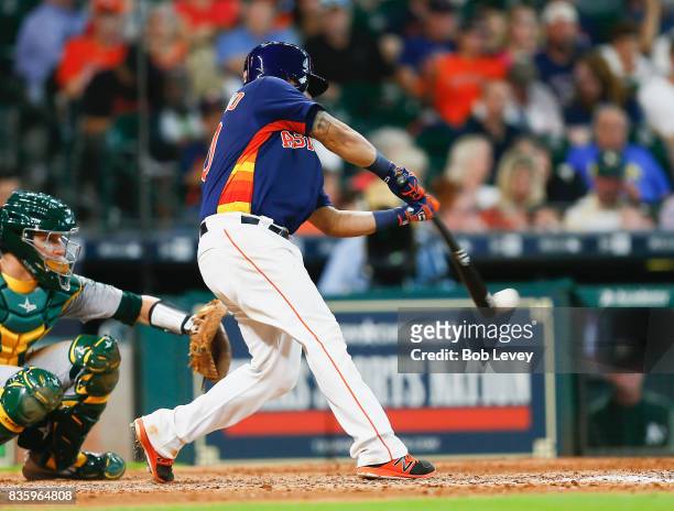 Juan Centeno of the Houston Astros singles in the seventh inning against the Oakland Athletics at Minute Maid Park on August 20, 2017 in Houston,...