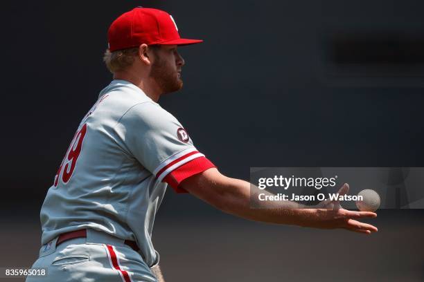 Ben Lively of the Philadelphia Phillies tosses to first base to force out Denard Span of the San Francisco Giants during the first inning at AT&T...